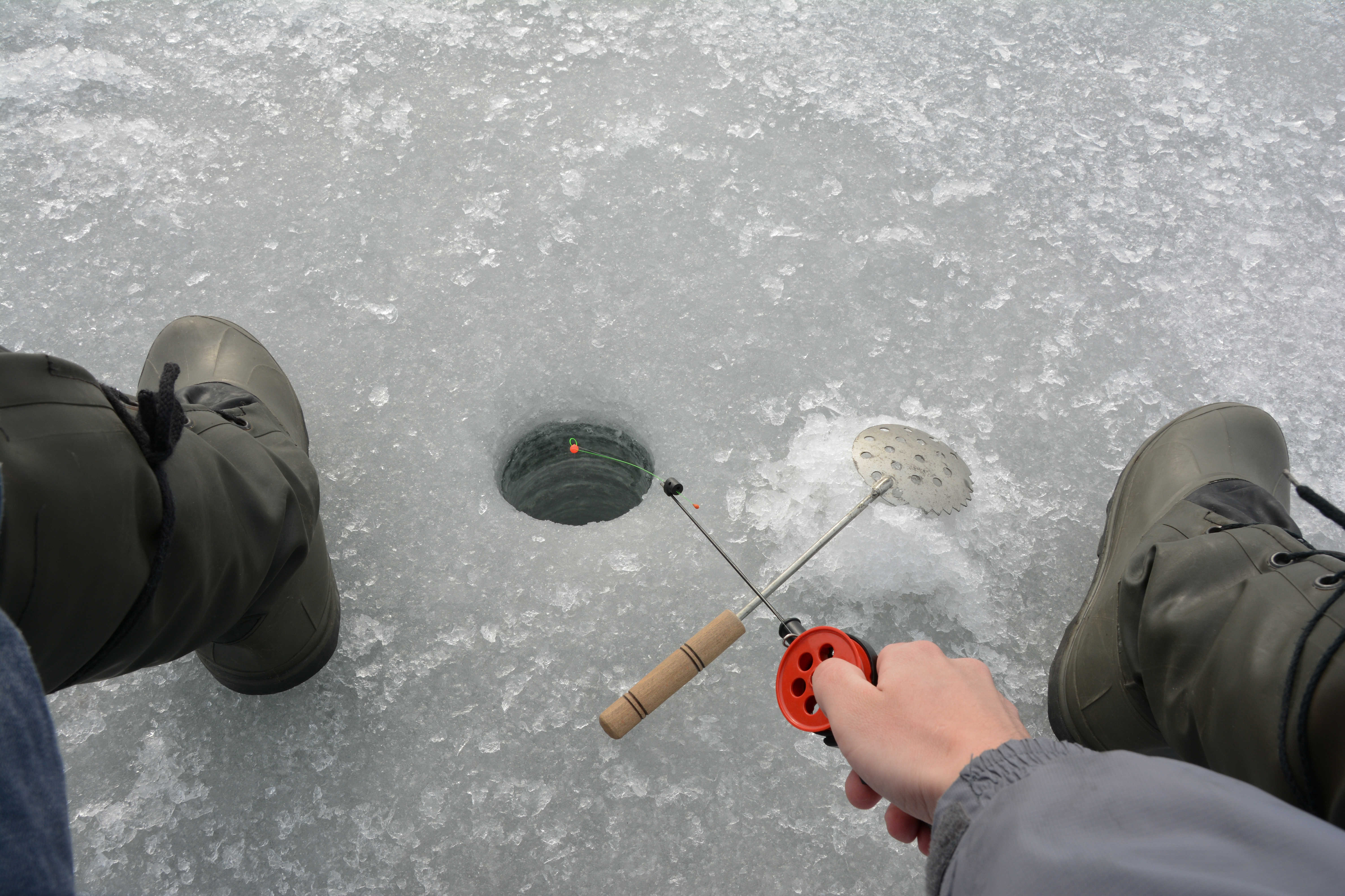 Ice fishing from above Avis Alaska