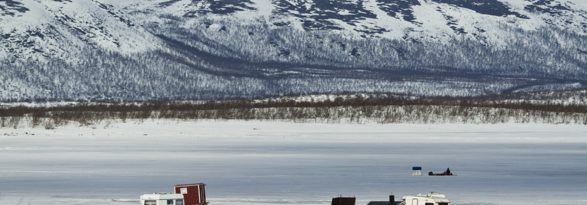 ice fishing on a frozen lake