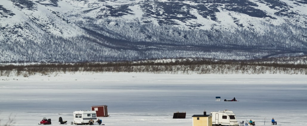 ice fishing on a frozen lake